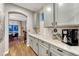 Kitchen featuring gray cabinets, white backsplash, white countertops, and stainless steel appliances at 13053 Umatilla Ct, Denver, CO 80234
