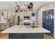 Kitchen featuring a stainless steel fridge, light gray cabinets, and dark island with a sink at 13053 Umatilla Ct, Denver, CO 80234
