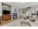 Cozy living room featuring a fireplace, seating area, and stairs to the second floor at 13053 Umatilla Ct, Denver, CO 80234
