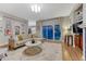 Open-concept living area featuring hardwood floors, natural light, and a patio door at 13053 Umatilla Ct, Denver, CO 80234
