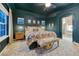 Main bedroom featuring a carpeted floor, moody decor, and ample natural light at 13053 Umatilla Ct, Denver, CO 80234