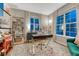 Bright office space with large windows, a modern desk, and stylish decor and a bookcase at 13053 Umatilla Ct, Denver, CO 80234