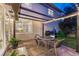Covered patio with dining table, chairs, and grill; view of the home at 13053 Umatilla Ct, Denver, CO 80234
