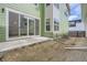 Backyard with a concrete patio, green siding, and sliding glass doors at 910 Promenade Dr, Superior, CO 80027