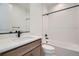Modern bathroom featuring a single sink, quartz countertops, and a shower with subway tile at 910 Promenade Dr, Superior, CO 80027