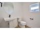 Clean bathroom featuring a pedestal sink, small vanity, and toilet at 910 Promenade Dr, Superior, CO 80027