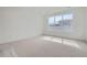 Bright bedroom featuring clean carpet and a large window offering natural light at 910 Promenade Dr, Superior, CO 80027