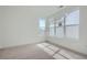 Bright bedroom featuring carpet, base trim, and a window offering natural light at 910 Promenade Dr, Superior, CO 80027