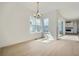 Bright dining area with hardwood floors, modern chandelier, and access to the living area at 910 Promenade Dr, Superior, CO 80027