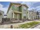 Charming two-story home with green siding, well-manicured lawn, and sidewalk at 910 Promenade Dr, Superior, CO 80027