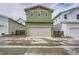 Modern exterior with green siding and a two-car garage at 910 Promenade Dr, Superior, CO 80027