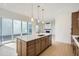 Bright kitchen with a large island, light wood floors, and stainless steel appliances at 910 Promenade Dr, Superior, CO 80027