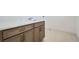 Laundry area features a white countertop, wooden cabinets, and neutral tiling at 910 Promenade Dr, Superior, CO 80027