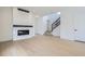 Modern living room featuring a sleek fireplace, hardwood floors and stairs at 910 Promenade Dr, Superior, CO 80027