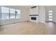 Modern living room featuring a sleek fireplace, hardwood floors and large windows at 910 Promenade Dr, Superior, CO 80027