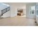 Open-concept living room with hardwood floors, stairs and contemporary design at 910 Promenade Dr, Superior, CO 80027