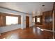 Spacious living room featuring hardwood floors and wood paneling at 5063 W Center Dr, Denver, CO 80219