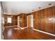 Hardwood floors and wood paneled walls in the living room at 5063 W Center Dr, Denver, CO 80219