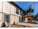 Home exterior showcasing a deck and stairs leading to a second story balcony at 11922 W 77Th Dr, Arvada, CO 80005