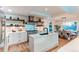 Elegant kitchen featuring white cabinetry and marble backsplash at 11922 W 77Th Dr, Arvada, CO 80005