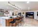 Gourmet kitchen boasts a large island with seating and a breakfast bar at 11922 W 77Th Dr, Arvada, CO 80005