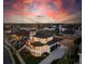 Expansive aerial view of a modern home with a sleek design in a residential neighborhood, set against a dramatic sky at 8240 W Tennessee Ave, Lakewood, CO 80226