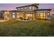 Beautifully landscaped backyard with a patio, pergola, and inviting fire pit area at 8240 W Tennessee Ave, Lakewood, CO 80226