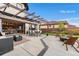 Spacious backyard featuring an outdoor patio and transition into an open concept dining room and kitchen area at 8240 W Tennessee Ave, Lakewood, CO 80226