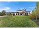 Expansive backyard featuring a well-maintained lawn and a stylish patio area with modern outdoor furniture at 8240 W Tennessee Ave, Lakewood, CO 80226