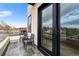 Modern balcony with stone flooring, outdoor seating, and a view of the neighborhood at 8240 W Tennessee Ave, Lakewood, CO 80226