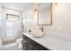 Bathroom with stone vessel sink, granite countertop, and frameless shower with bronze hardware at 8240 W Tennessee Ave, Lakewood, CO 80226