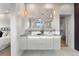 Bathroom featuring double sink vanity with gray marbled countertops, modern lighting and mirrors, and access to the bedroom at 8240 W Tennessee Ave, Lakewood, CO 80226
