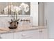 Close up view of a bathroom featuring a marble vanity with modern faucet and a decorative white orchid at 8240 W Tennessee Ave, Lakewood, CO 80226