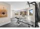 Bright exercise room with rubber flooring, large windows, and a variety of fitness equipment at 8240 W Tennessee Ave, Lakewood, CO 80226