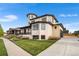 Charming home showcasing a well-manicured lawn, modern architecture, and inviting curb appeal at 8240 W Tennessee Ave, Lakewood, CO 80226