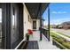 Charming front porch with a dark wood bench and black railings, accented by lush landscaping and a welcoming entrance at 8240 W Tennessee Ave, Lakewood, CO 80226