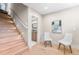 Hallway with wooden staircase with inset lighting and a stylish powder room off to the side at 8240 W Tennessee Ave, Lakewood, CO 80226