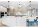Bright, modern kitchen with sleek cabinetry, a central island, and stylish pendant lighting, creating an inviting atmosphere at 8240 W Tennessee Ave, Lakewood, CO 80226
