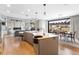 Open-concept kitchen with a large island, stainless steel appliances, and seamless flow to the dining and living area at 8240 W Tennessee Ave, Lakewood, CO 80226