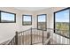 Landing with metal railing and large black windows looking out to scenic views of the surrounding landscape at 8240 W Tennessee Ave, Lakewood, CO 80226