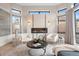 Cozy living room with a modern fireplace, flanked by stylish sconces and luxurious armchairs at 8240 W Tennessee Ave, Lakewood, CO 80226