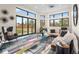 Bright living room with large windows, offering views of the beautifully landscaped backyard at 8240 W Tennessee Ave, Lakewood, CO 80226