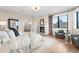 This bedroom features a cozy fireplace, light hardwood floors, and an oversized window to let in natural light at 8240 W Tennessee Ave, Lakewood, CO 80226