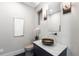 Stylish powder room with unique sink, custom lighting, and designer accents at 8240 W Tennessee Ave, Lakewood, CO 80226