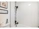 Bright bathroom features a modern shower head and tiled backsplash, perfect for a fresh start to the day at 3231 S Estes St, Lakewood, CO 80227