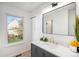 Bright bathroom showcases granite countertops, modern fixtures, and a large mirror at 3231 S Estes St, Lakewood, CO 80227