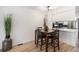 Cozy dining area features wooden table and chairs next to a white breakfast bar, perfect for casual meals at 3231 S Estes St, Lakewood, CO 80227