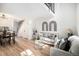 Bright living room area features stylish decor, hardwood floors, and an adjacent dining area at 3231 S Estes St, Lakewood, CO 80227