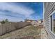 Fenced backyard with a mix of grass and landscaping, providing a private outdoor space at 12291 Coral Burst Ct, Parker, CO 80134