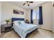 Cozy bedroom with striped bedding, neutral walls, and bright natural light from the window at 12291 Coral Burst Ct, Parker, CO 80134